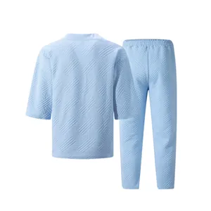 Detailed view of the quilted jacquard texture on this light blue men's two-piece set