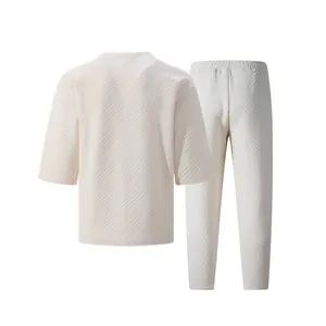 Detailed view of cream-colored men's leisure set with geometric jacquard texture