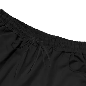 Close-up detail of black men's cargo shorts showing elastic waistband and drawstring.
