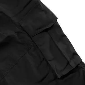 Close-up of black cargo shorts featuring a durable side pocket with stitching details