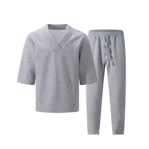 Close-up of grey jacquard textured men's leisure V-neck top and matching pants