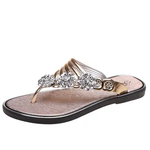 Elegante Damen Flip-Flops in Gold mit dekorativen floralen Strassstein-Akzenten