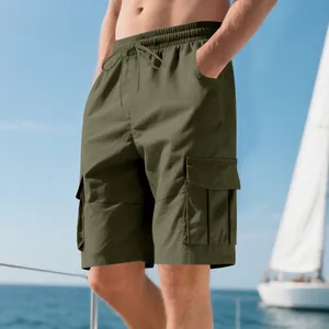 Detailed side view of men's olive green cargo shorts with large flap pockets on a boat