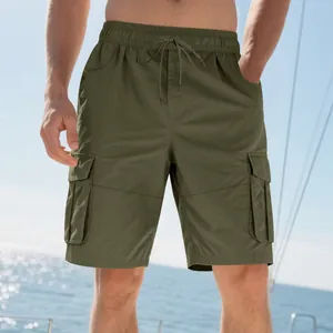Detailed view of olive green cargo shorts with multiple pockets and drawstring waist