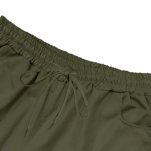 Close-up detail of olive green men's cargo shorts featuring an elastic drawstring waistband