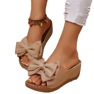 Stylish women's platform wedge sandals with elegant bow detail for summer beach vacations