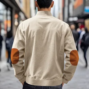 Back view of men's minimalist beige corduroy jacket featuring vintage orange elbow patches