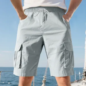 Close-up detail of men's light gray multi-pocket cargo shorts with drawstring waist