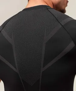Close-up of breathable mesh fabric and ergonomic stitching on a black fitness t-shirt.