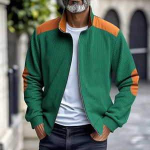 Detailed view of men's green ribbed jacket featuring stylish orange shoulder and elbow patches