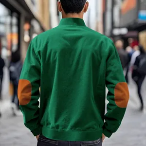 Back view of men's green corduroy jacket with brown elbow patches in street setting
