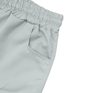 Close-up detail of light gray cargo shorts showing elastic waistband and side pocket