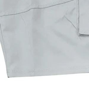 Detailed macro shot showing light grey twill fabric and durable double stitching on cargo shorts