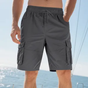Close-up of men's dark grey loose cargo shorts with multiple pockets and drawstring.