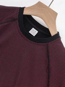 Close-up of a men's red and black athletic sports T-shirt with breathable mesh texture.