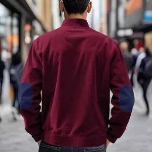Back view of men's vintage burgundy corduroy jacket featuring blue contrast elbow patches