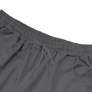 Close-up detail of men's cargo shorts featuring elastic waistband and drawstring.
