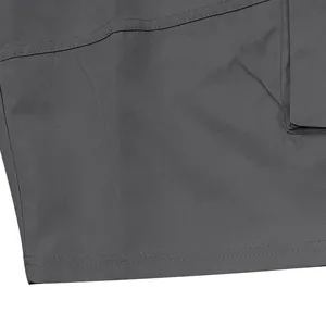 Macro view of grey cargo shorts detailing the durable twill fabric and reinforced stitching