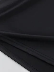 Detail view of high-quality stitching and quick-dry fabric texture of black sports T-shirt.