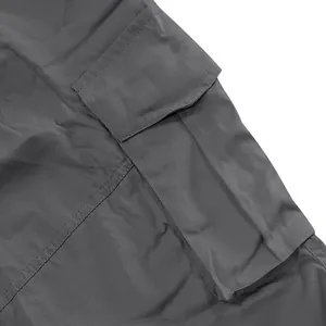 Detail of side cargo pocket on grey men's loose cargo shorts with durable stitching