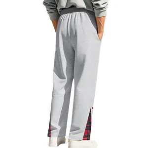 Vista dettagliata dei pantaloni sportivi pesanti grigi da uomo con inserti a quadri