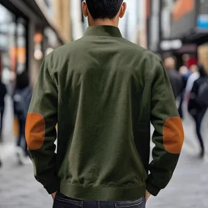 Back view of olive green corduroy jacket with orange elbow patches for men