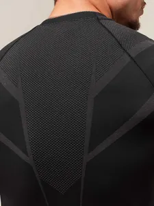 Back view of a black men's compression t-shirt with breathable honeycomb mesh texture