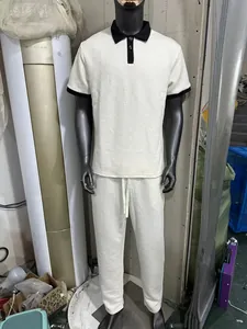 Full view of men's white jacquard knit polo shirt and long pants set for summer leisure