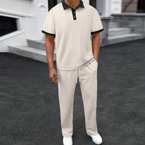 Detailed view of men's summer jacquard polo and pants set in beige with black accents