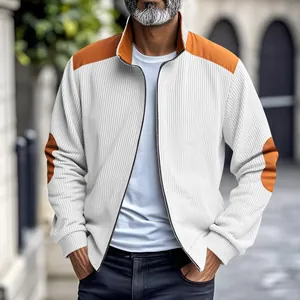 Close-up view of a men's vintage white corduroy jacket featuring orange shoulder patches