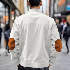 Back view of men's white corduroy jacket with brown elbow patches in urban setting