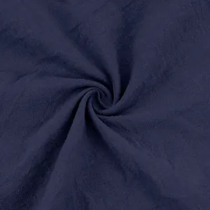 Close-up of navy blue linen fabric texture showing natural weave and breathability