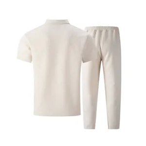 Back view of men's off-white textured waffle knit polo and matching pants set