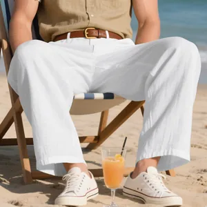 Image de style de vie d'un pantalon en lin blanc ample pour homme sur la plage.