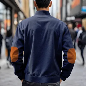 Detailed back view of a heavyweight navy corduroy jacket with brown elbow patches.