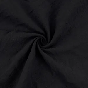 Detailed close-up showing the breathable texture of black linen fabric for men's pants.