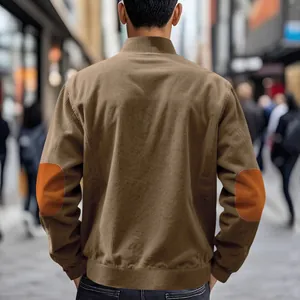 Detailed back view of a men's brown corduroy jacket with contrast orange elbow patches