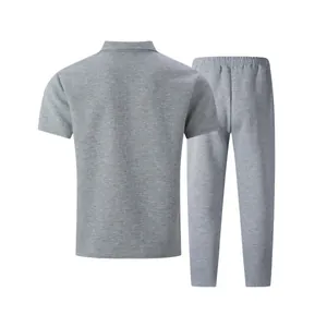 Back view of a men's grey textured short-sleeve polo shirt and trousers casual set