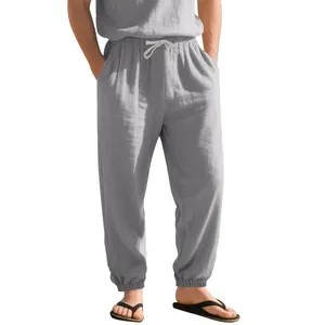 Detail view of grey linen joggers featuring drawstring waist and elastic cuffs