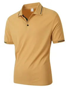Detailed view of mustard yellow jacquard polo shirt with black striped collar and cuffs