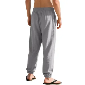 Rear view of men's loose grey linen joggers with elastic ankle cuffs and waistband