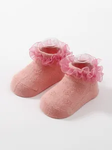 Close-up detail of the elegant pink ruffle lace trim on breathable baby princess socks