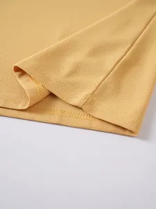 Macro detail showing the intricate yellow jacquard waffle fabric on a men's polo shirt.
