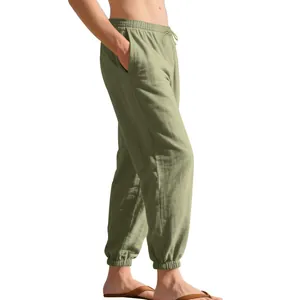 Detailed side view of men's loose olive green linen jogger pants with drawstring