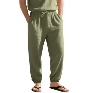 Detail view of green linen jogger pants with drawstring waist and elastic cuffs