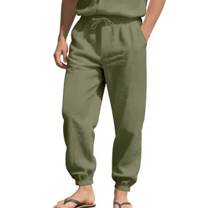 Detail shot of men's loose linen joggers featuring drawstring waist and elastic cuffs.