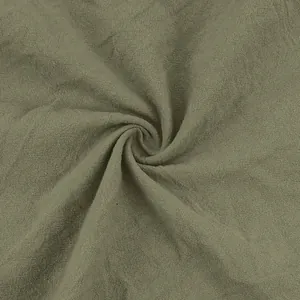 Macro detail shot showing the breathable texture of olive green linen fabric for men's pants