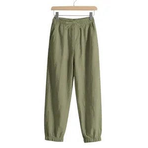 Olive green loose fit linen joggers for men with drawstring waist and elastic cuffs.