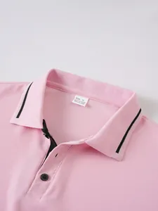 Close-up detail of pink men's polo shirt featuring striped collar and black buttons