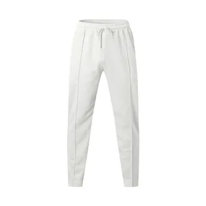 Detail shot of white men's joggers featuring drawstring waist and front seams.